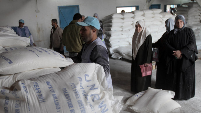 Palestinians wait to receive their monthly food aid at a UN distribution center in the Shati refugee camp, in Gaza City, on January 17, 2012. (AFP Photo/Said Khatib)