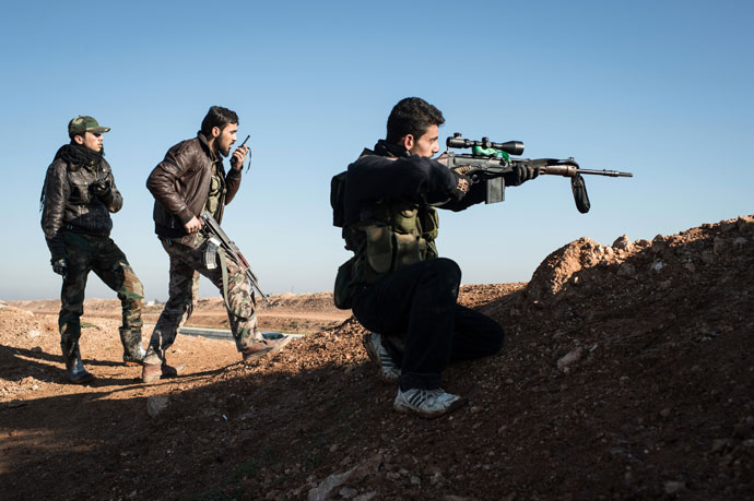 A Syrian rebel sniper takes aim at pro-government forces near the Abu Baker brigade in Albab, 30 kilometres from the northeastern Syrian city of Aleppo.(AFP Photo / Edouard Elias)