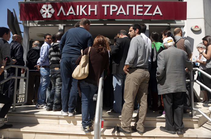 People queue up outside a Laiki bank branch in the Cypriot capital, Nicosia, on March 28, 2013, as they wait for the bank to open after an unprecedented 12-day lockdown (AFP Photo / Patrick Baz)