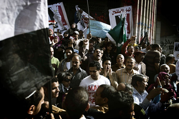 Hundreds of Egyptian political activists, victims and prisoners' relatives shout slogans during a protest against current prosecutor general Talaat Abdallah outside Cairo High Court on March 29, 2013 in Egypt.(AFP Photo / Gianluigi Guercia)