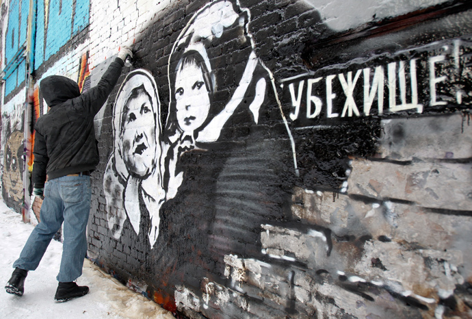 Russian street artist P183 paints a mural dedicated to forthcoming elections on a wall in central Moscow (Reuters / Sergei Karpukhin)