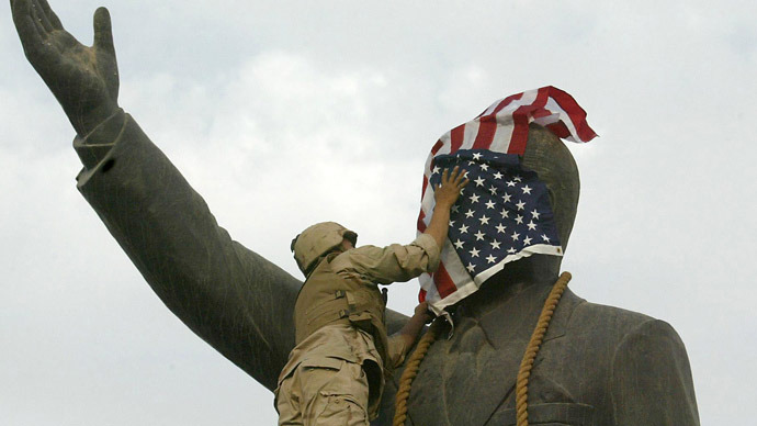 A file picture shows a US Marine covering the face of Iraqi President Saddam Hussein's statue with the US flag in Baghdad's al-Fardous square on April 9, 2003. (AFP Photo/Ramzi Haidar)