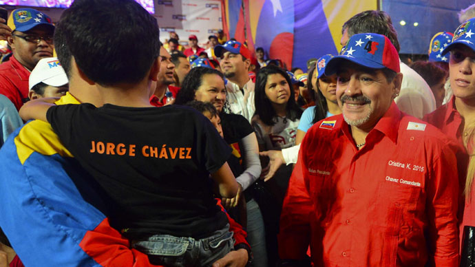 Argentina's football legend Diego Maradona (R) takes part in the closing rally of the electoral campaign of Venezuelan acting President and presidential candidate Nicolas Maduro (out of frame) in Caracas on April 11, 2013.(AFP Photo / Luis Acosta)