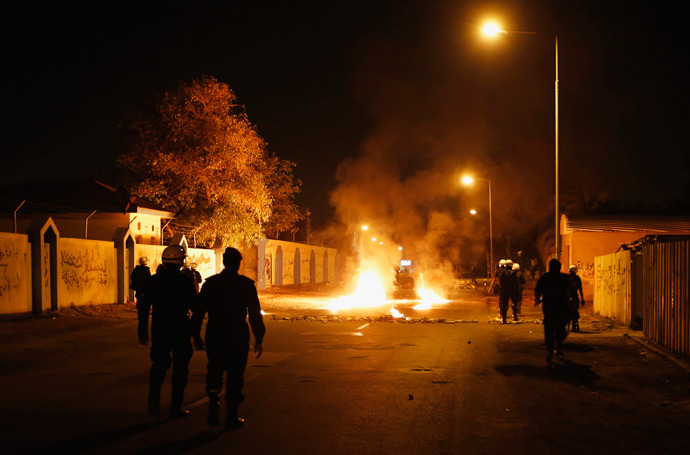 Riot police officers secure the area where burning tyres were set up by anti-government protesters in the village of Diraz, west of Manama, April 11, 2013 (Reuters / Hamad I Mohammed)