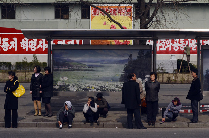 North Koreans wait for a bus in Pyongyang on April 11, 2012. (AFP Photo/Pedro Ugarte)