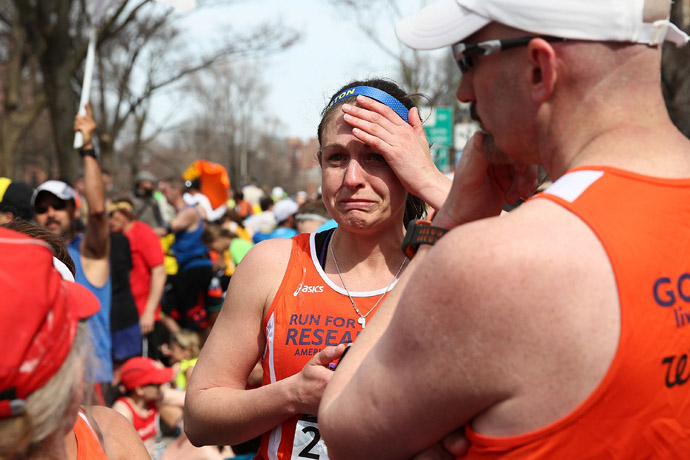 A runner reacts near Kenmore Square after two bombs exploded during the 117th Boston Marathon on April 15, 2013 in Boston, Massachusetts (Alex Trautwig / Getty Images / AFP)