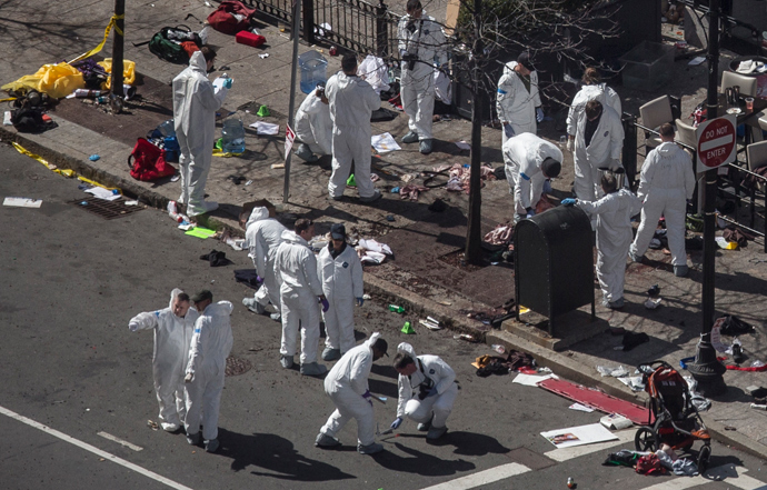 Investigators survey the site of a bomb blast on Boylston Street a day after two explosions hit the Boston Marathon in Boston, Massachusetts April 16, 2013 (Reuters / Adrees Latif)
