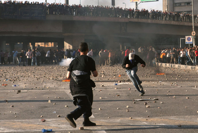 An anti-Mursi protester is hit by a stone while another (L) throws a stone at Muslim Brotherhood members and supporters of Egyptian President Mohamed Mursi, during clashes in Tahrir Square in Cairo, April 19, 2013.(Reuters / Asmaa Waguih)