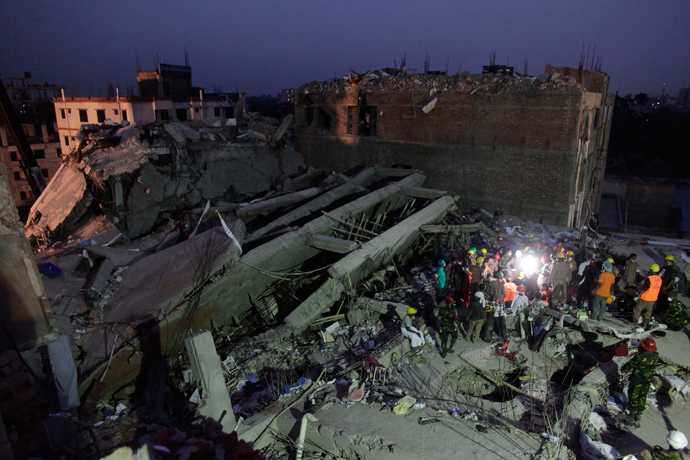 Rescue workers attempt to rescue garment workers from the rubble of the collapsed Rana Plaza building, in Savar, 30 km (19 miles) outside Dhaka April 28, 2013 (Reuters / Andrew Biraj)