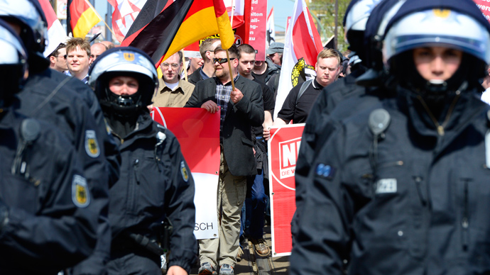 Supporters of Germany's right extremist National Democratic Party (NPD) wave flags as they take part in a neonazi demonstration on May 1, 2013 in Berlin (AFP Photo / John Macdougall)