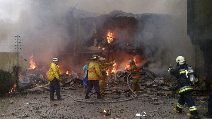 At least 2 dead as plane crashes into residential building in Venezuela (PHOTOS)