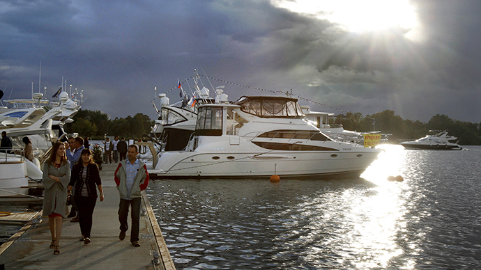 Prospective clients walk past yachts during the Millionaire Boat Show at the Royal Yacht Club in Moscow. (Reuters / Sergei Karpukhin)