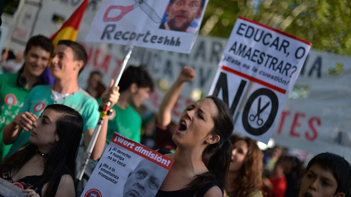 Students react as they take part with thousands of people in a protest against the government's cuts to education spending in Madrid, on May 9, 2013.(AFP Photo / Pedro Armetre)
