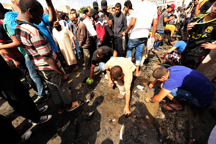 People clear debris at the scene of a car bomb explosion outside a hospital in Benghazi May 13, 2013 (Reuters / Esam Al-Fetori)