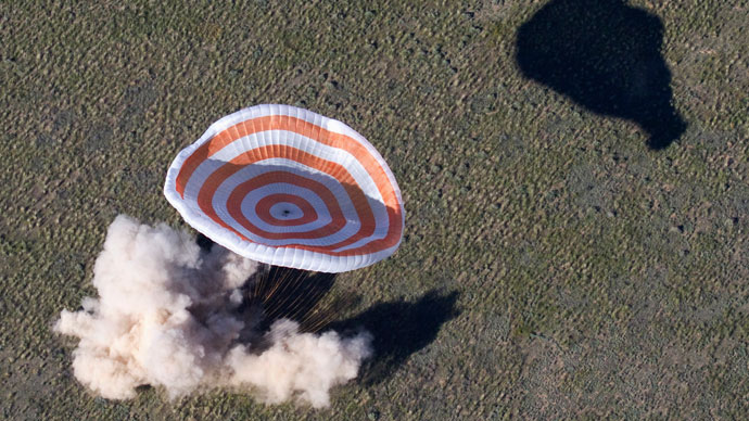 The Russian Soyuz space capsule, carrying U.S. astronaut Tom Marshburn, Russian cosmonaut Roman Romanenko and Canadian astronaut Chris Hadfield, lands some 150 km (90 miles) southeast of the town of Zhezkazgan, in central Kazakhstan May 14, 2013.(Reuters / Sergei Remezov)