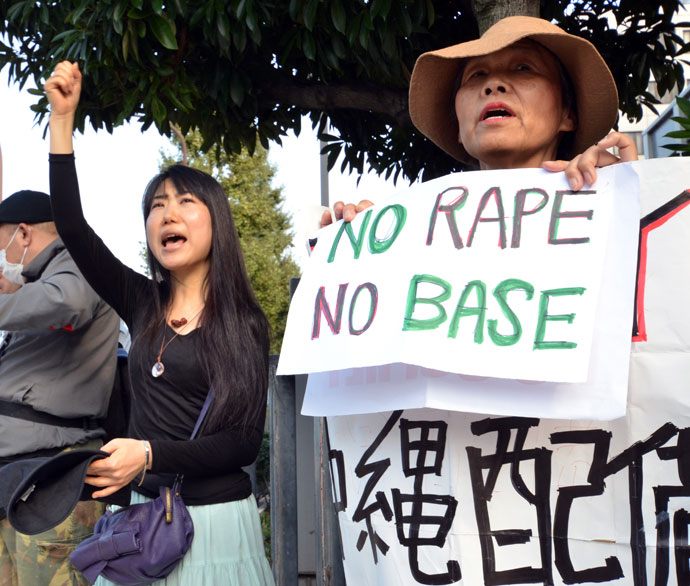 Civic group members shout slogans and hold placards as they attend a protest over the alleged rape of a local woman by two US servicemen in Okinawa, in front of the prime minister's official residence in Tokyo on October 20, 2012.(AFP Photo / Yoshikazu Tsuno)