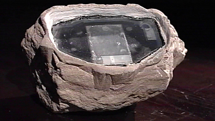 A picture broadcast by the Russian state-run Rossiya television and grabbed on Euronews channel 23 January 2006 shows a stone being used as a high-tech version of the spy's traditional letter-box or dead drop in which agents can anonymously deliver or retrieve information. (AFP/Euronews)