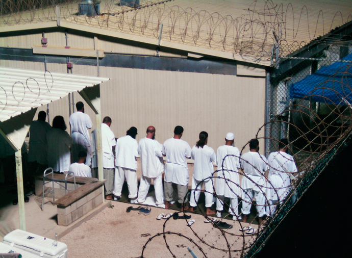 Detainees participate in an early morning prayer session at Camp IV at the detention facility in Guantanamo Bay U.S. Naval Base (Reuters / Deborah Gembara)