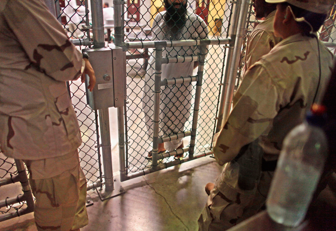 In this photo, reviewed by the U.S. military, a Guantanamo detainee speaks with guards inside the Camp 6 detention facility at Guantanamo Bay U.S. Naval Base in Cuba (Reuters / Brennan Linsley)