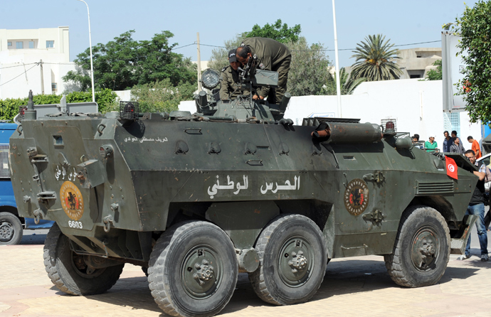 Tunisian members of the national guard stand guard on their vehicle outside the Okba Ibn Nafaa mosque in the central Tunisian city of Kairouan on May 19, 2013 (AFP Photo / Fethi Belaid)