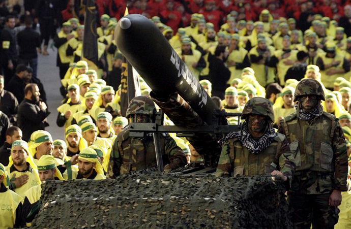 Lebanese Shiite Muslim Hezbollah militants ride on a vehicle. (AFP Photo / Mahmoud Zayyat)
