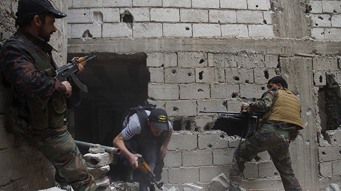Free Syrian Army fighters lay cover fire after what they say was during clashes with forces loyal to President Bashar al-Assad in Deir al-Zor May 13, 2013. (Reuters)