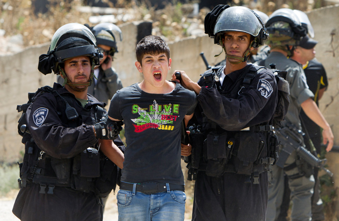 A Palestinian youth is arrested by Israeli security as bulldozers destroy a Palestinian home in Arab east Jerusalem's neighborhood of Beit Hanina, on May 29, 2013 (AFP Photo / Ahmad Gharabli) 