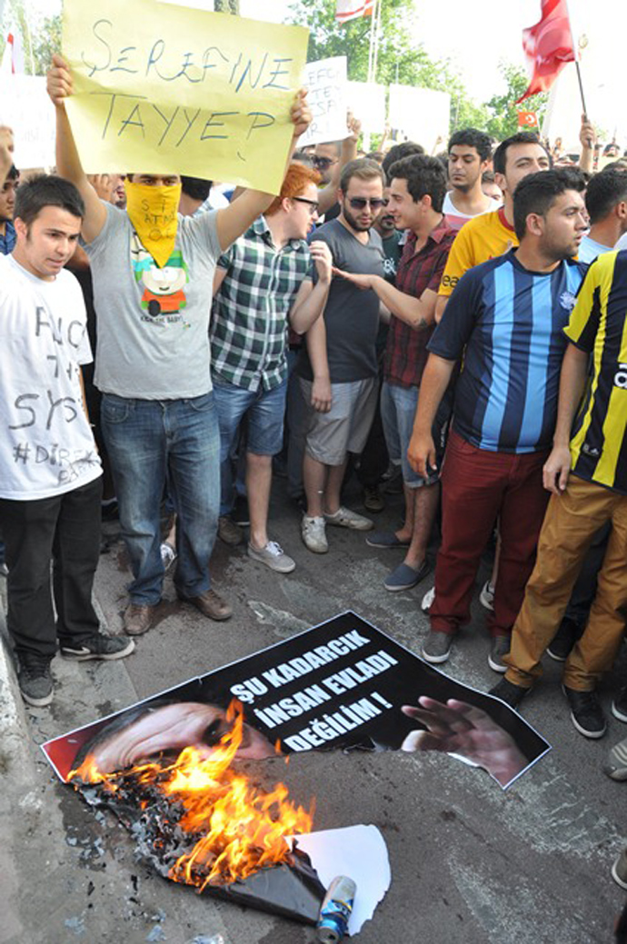 Protesters burn the image of Turkish PM Recep Tayyip Erdogan at the 'Solidarity with people in Turkey and Taksim Squareâ demonstration in Nicosia, Cyprus / Photo by Melis Tutan