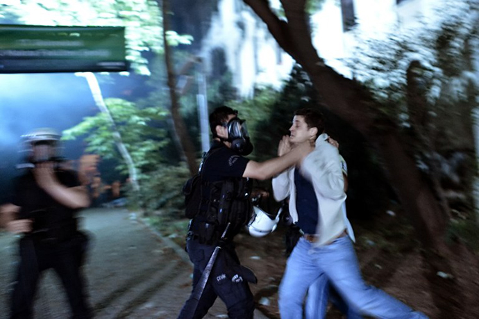 A riot policeman detains a demonstrator in Istanbul on June 4, 2013. (AFP Photo / Aris Messinis)