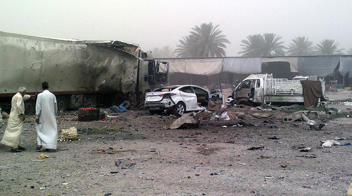 Civilians gather at the site of a car bomb attack at Jadidat al-Shatt in Diyala province, 40 km (25 miles) north of Baghdad, June 10, 2013. (Reuters)