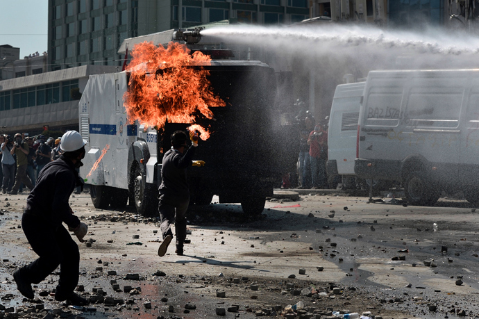 A protester throws a Molotov cocktail during clashes with riot police in Istanbul's Taksim square on June 11, 2013 (AFP Photo / Aris Messinis)