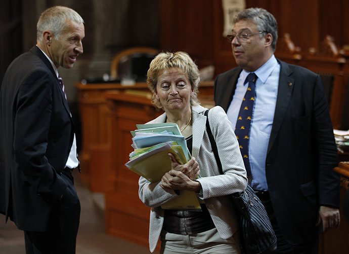 Swiss Finance Minister Eveline Widmer-Schlumpf leaves the Council of State for a break during a debate on the tax agreement between Switzerland and the U.S. in Bern June 12, 2013. (Reuters / Ruben Sprich)
