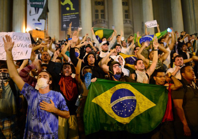 Demonstrators shout slogans outside the Municipal theatre in downtown Rio de Janeiro on June 17, 2013. (AFP Photo / Christophe Simon)