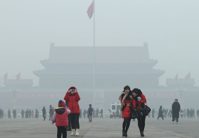Visitors take pictures on Tiananmen Square during a foggy day in central Beijing, January 29, 2013. China issued a blue-coded alert on Sunday as foggy weather forecast for the coming two days will cut visibility and worsen air pollution in some central and eastern Chinese cities, Xinhua News Agency reported.(Reuters / China Daily) 