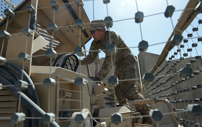 An US soldier from the 10th Mountain Division checks a Maxxpro Mine Resistant Ambush Protected vechile prior to going on an operation at the Forward Operating Base Ghazni (AFP Photo / Dibyangshu Sarkar)