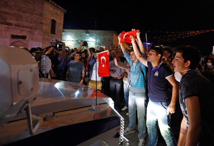 Protesters try to stop a riot police vehicle at Taksim Square in Istanbul June 22, 2013 (Reuters / Marko Djurica)