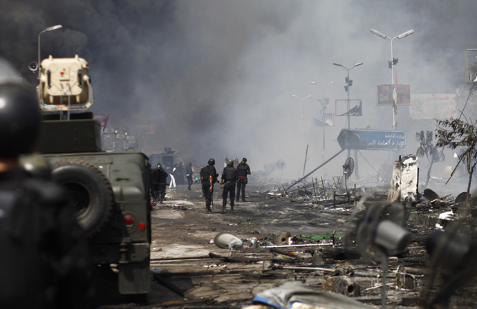 Egyptian security forces stand amidst remains of a protest camp by supporters of ousted president Mohamed Morsi and members of the Muslim Brotherhood after a crackdown on August 14, 2013 near Cairo's Rabaa al-Adawiya mosque (AFP Photo / Mahmoud Khaled)