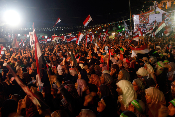 Supporters of Egypt's deposed President Mohamed Mursi shout slogans as they continue their sit-in outside the Rabaa Adawiya mosque, east of Cairo July 11, 2013 (Reuters / Asmaa Waguih)