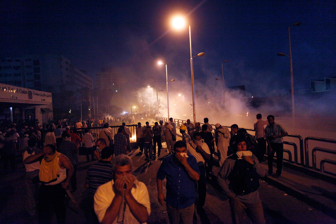 Egyptian supporters of the Muslim Brotherhood rallying in support of deposed president Mohamed Morsi run for cover during clashes with police outside the elite Republican Guards base in Cairo early on July 8, 2013 (AFP Photo / Mahmoud Khaled)