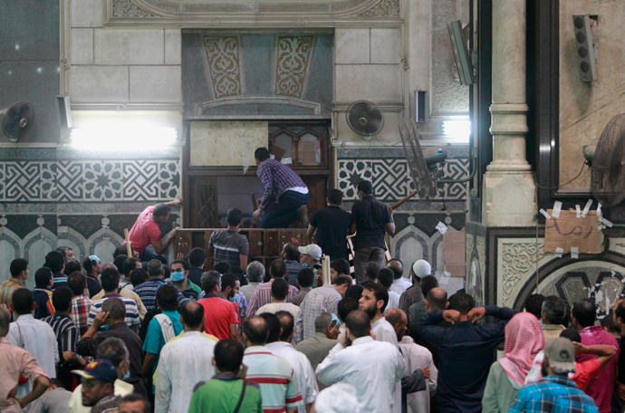 Demonstrators in support of ousted Egyptian President Mohamed Mursi wait by the barricaded door inside al-Fath mosque at Ramses Square in Cairo August 17, 2013 (Reuters / Mohamed Abd El Ghany)