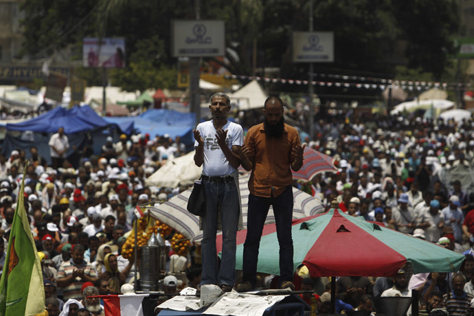 Supporters of Egyptian President Mohamed Morsi recite prayers during a rally to show support for him at the Raba El-Adwyia mosque square in Cairo July 3, 2013. (Reuters)