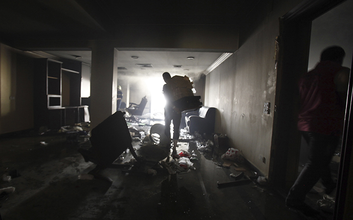 Looters carry furniture and other objects out of the Muslim Brotherhood's headquarters after it was burned down by protesters opposing Egyptian President Mohamed Morsi in Cairo's Moqattam district July 1, 2013. (Reuters / Amr Dalsh)