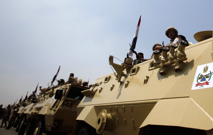 Members of the military keep guard on a road leading to the Raba El-Adwyia mosque square, where supporters of Egypt's deposed President Mohamed Mursi are camping at, in Cairo July 4, 2013 (Reuters / Khaled Abdullah)