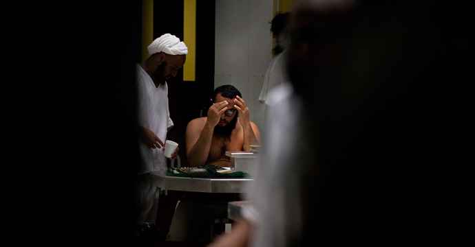 In this photo reviewed by US military officials, detainees gather during lunch in a communial area inside Camp VI at the US Detention Center in Guantanamo Bay, Cuba, March 30, 2010 (AFP Photo / Paul J. Richards)