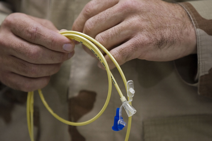Captain Ronald Sollock, Medical Joint Force HQ Surgeon holding one of the "feeding tubes" used at Camp Delta on the US Naval base at Guantanamo Bay, Cuba (AFP Photo / Paul J. Richards)
