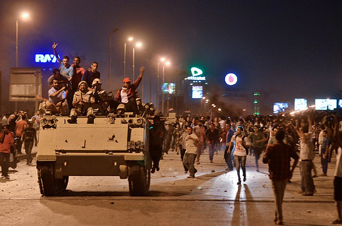 Protesters cheer upon the arrival of the Egyptian Security Forces during clashes between ousted president Mohamed Morsi supporters and anti-Morsi protesters near Egypt's landmark Tahrir square on July 5, 2013 in Cairo, Egypt. (AFP Photo / Mohamed El-Shahed)