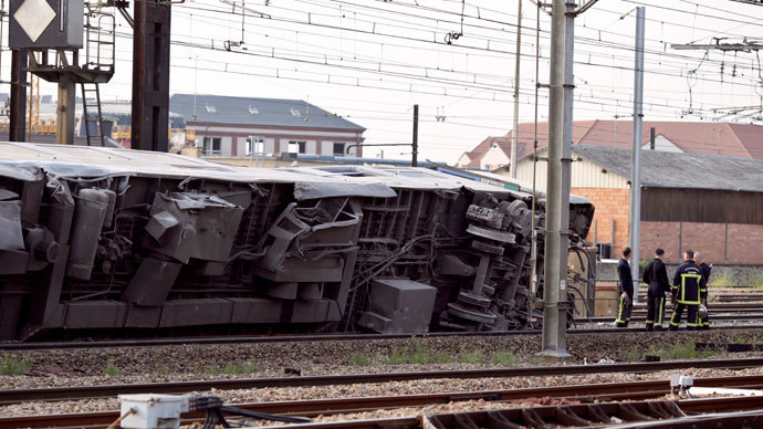 A picture shows a derailed wagon on the site of a train accident in the railway station of Bretigny-sur-Orge on July 12, 2013 near Paris.(AFP Photo / Kenzo Tribouillard)