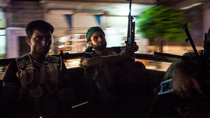 Syrian rebels head to the town of Bsankol in the northwestern province of Idlib to join comrades fighting regime forces for the control of the highway that connects Idlib with Latakia on July 11, 2013. (AFP Photo / Daniel Leal Olivas)