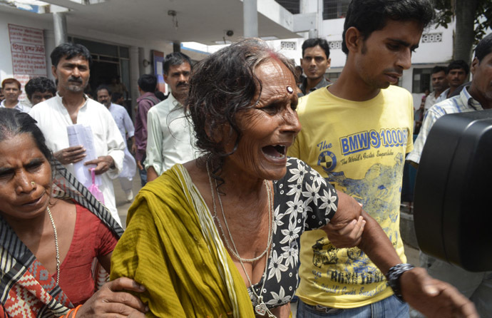 A woman cries after her grandson, who consumed spurious meals at a school on Tuesday, died at a hospital in the eastern Indian city of Patna July 17, 2013. (Reuters)