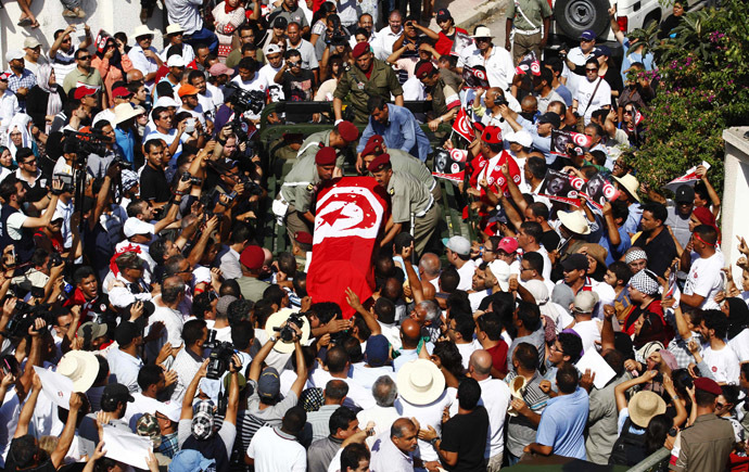 Mourners carry the coffin of slain opposition leader Mohamed Brahmi during his funeral procession towards the nearby cemetery of El-Jellaz, where he is to be buried, in Tunis July 27, 2013. (Reuters/Zoubeir Souissi)